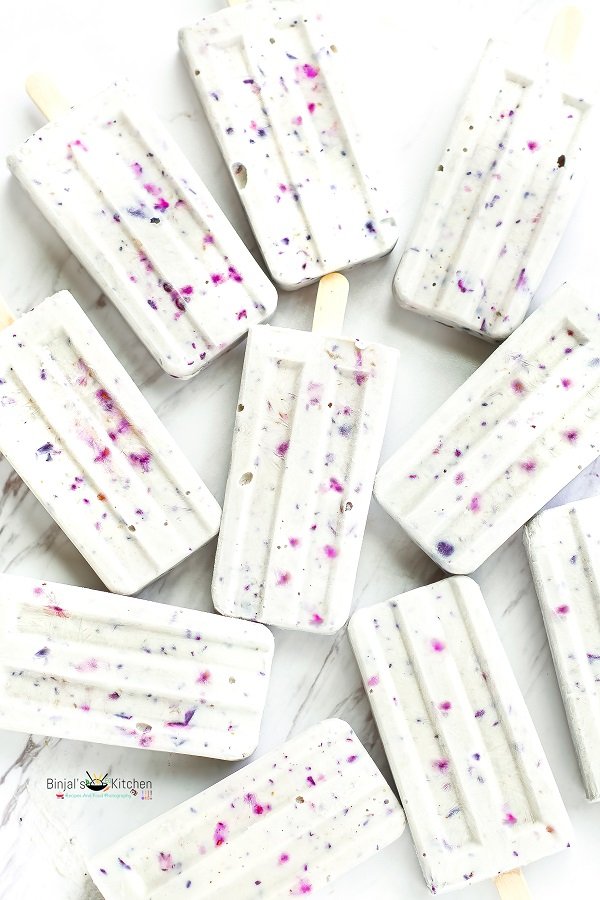 White rectangular bars with colorful specks scattered on a white surface.