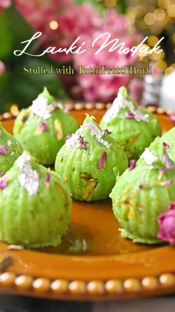 Lauki Modak Stuffed with Tutti Frutti Burfi 💚✨

Have you ever made Modak with Lauki? 😍

I know it sounds a little different, but trust me, these turned out SO good! The Lauki mixture is soft, creamy and mildly sweet, and then you get that little surprise of Tutti Frutti Burfi with nuts in the center. 😋

I shaped them in a Modak mold, added some chopped Pistachios and finished them with silver leaf, nuts and dried rose petals. They look so pretty on a festive platter! ✨

If you are looking for a different Modak recipe this Ganesh Chaturthi, definitely give this one a try. ❤️
.
Comment MODAK and I’ll send you the recipe in DM 📩
.
Follow @binjalsvegkitchen for more vegetarian recipes and festive sweets! 💚
.
Ganpati Bappa Morya ⚜️🪷