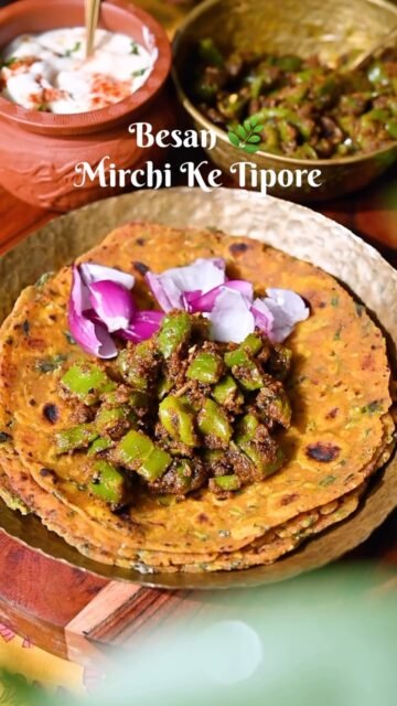 Besan Mirchi Ke Tipore is a delightful Rajasthani side dish that stands out for its unique balance of flavors and textures. This dish celebrates green chilies in a way that is distinct from their typical use as a garnish or spice element; here, they take center stage, coated in a flavorful, nutty layer of roasted gram flour (besan) and spices. This balance of tastes is what makes Besan Mirchi Tipore so popular on Rajasthani thalis, where it pairs beautifully with rotis, parathas, and rice.
.
Comment “ MIRCHI “ I’ll share with you in your DM/Inbox 
.
.
.
.
.
.
.
.
.
.
.